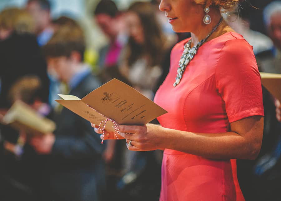 The brides sister looks through the church order of hymns