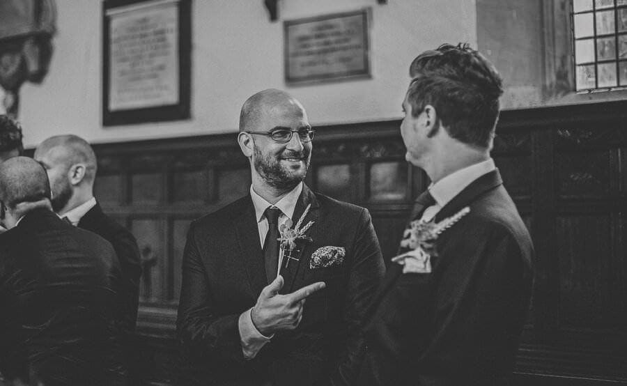 An usher shares a joke with a friend in the church