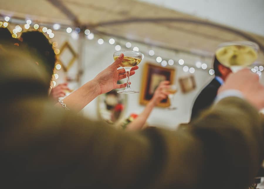 Champagne glasses are raised