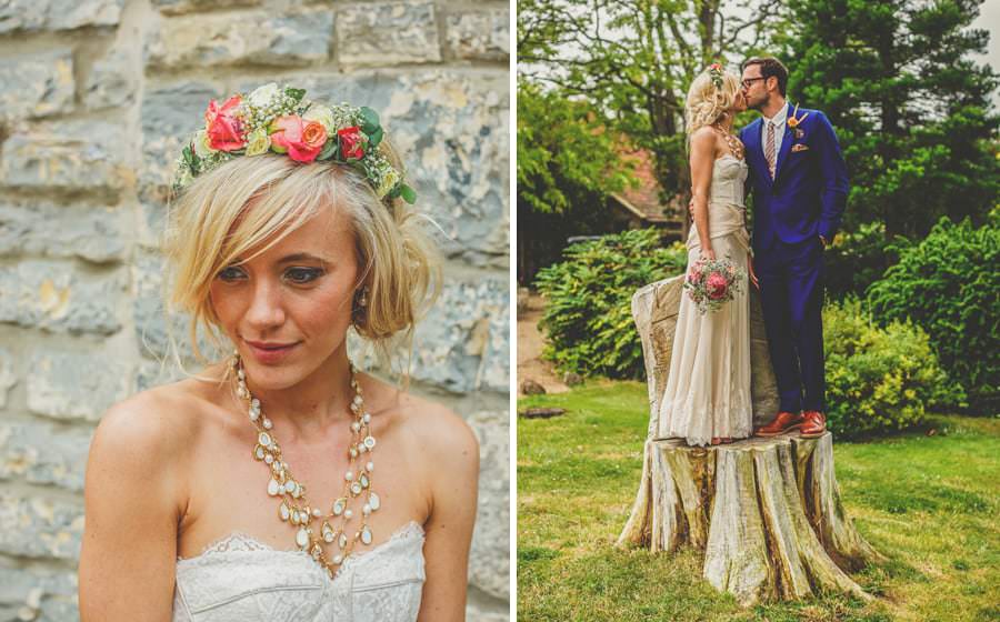 The bride and groom kiss each other on a tree trunk