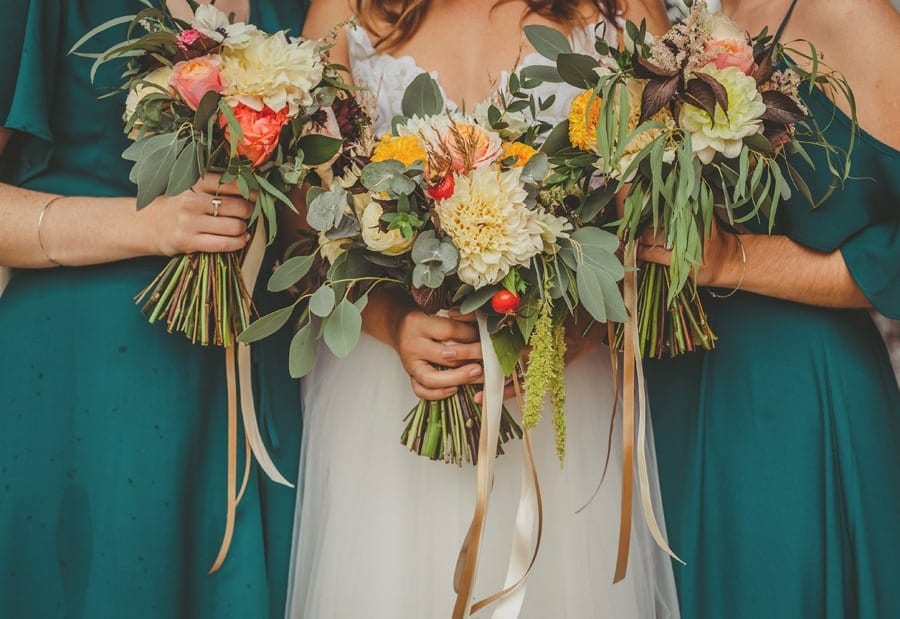 The bride and the bridesmaids pose for a photograph outside the church
