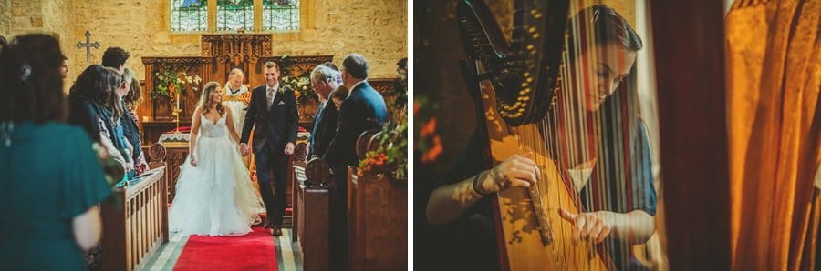 The bride and groom walk back from the alter hand in hand and a lady plays a harp