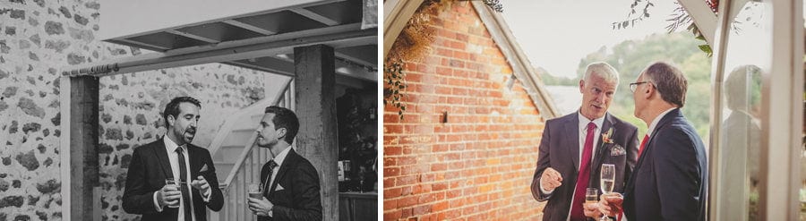 Wedding guests talk amongst themselves at the Tithe Barn in Dorset