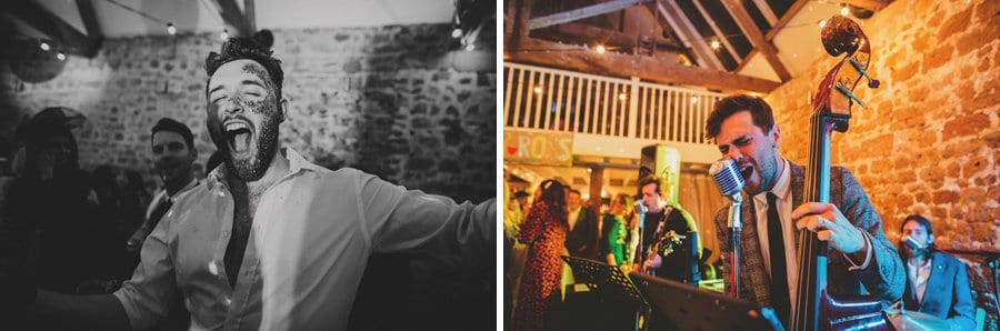 The singer of the wedding band sings into the large steel microphone and a wedding guest shouts at friends on the dance floor