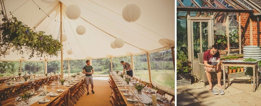 Wedding guests prepare the wedding dinner table in the marquee at Mill farm