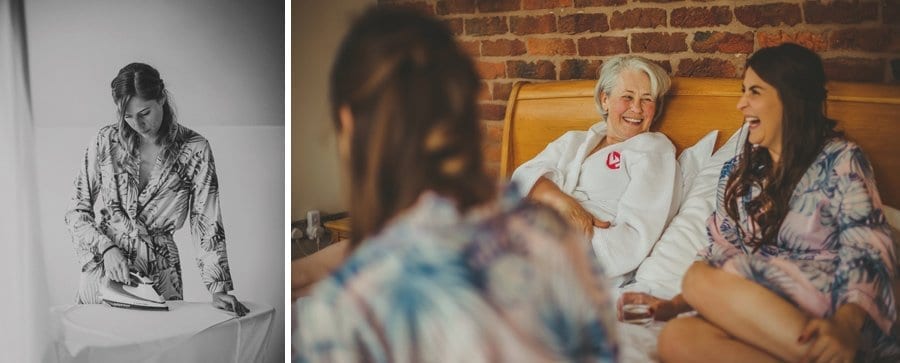 One of the bridesmaids irons her dress and the brides mother laughs with a friend
