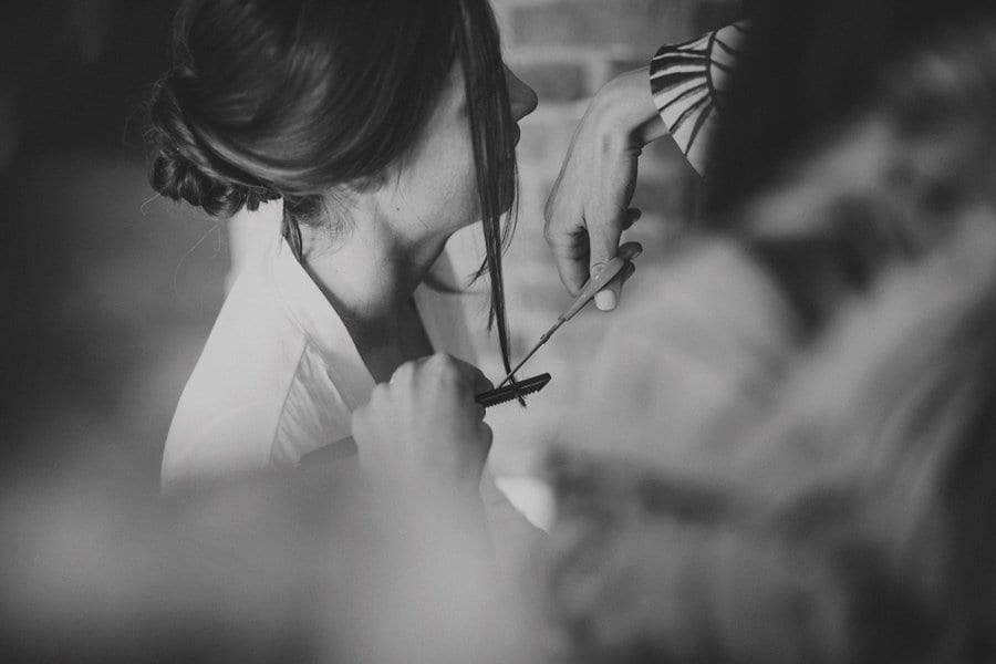 The hairdresser cuts the brides hair