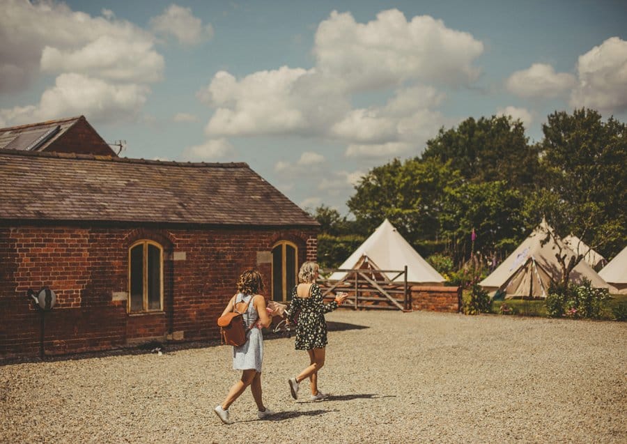 Wedding guests walking across the courtyard on the morning of the wedding