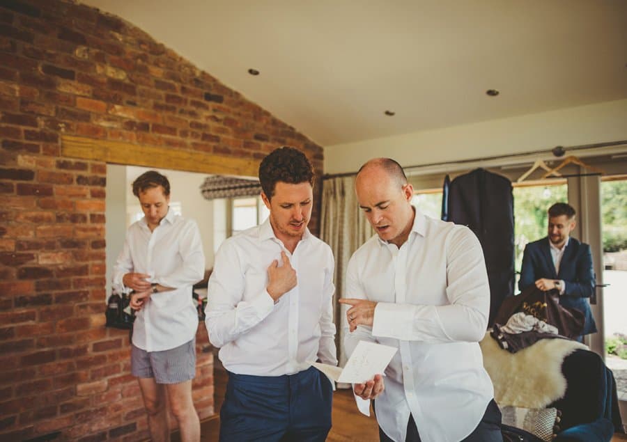 An usher points to the groom and delivers instructions for the outdoor ceremony