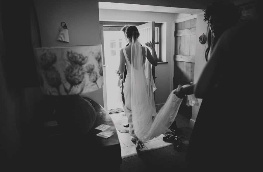 The bride and her bridesmaid walking into the courtyard