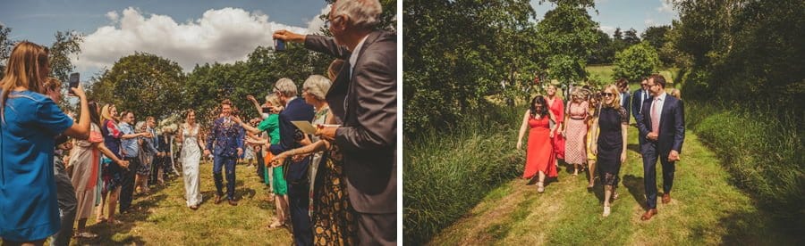Wedding confetti and wedding guests walking away from the ceremony towards the marquee