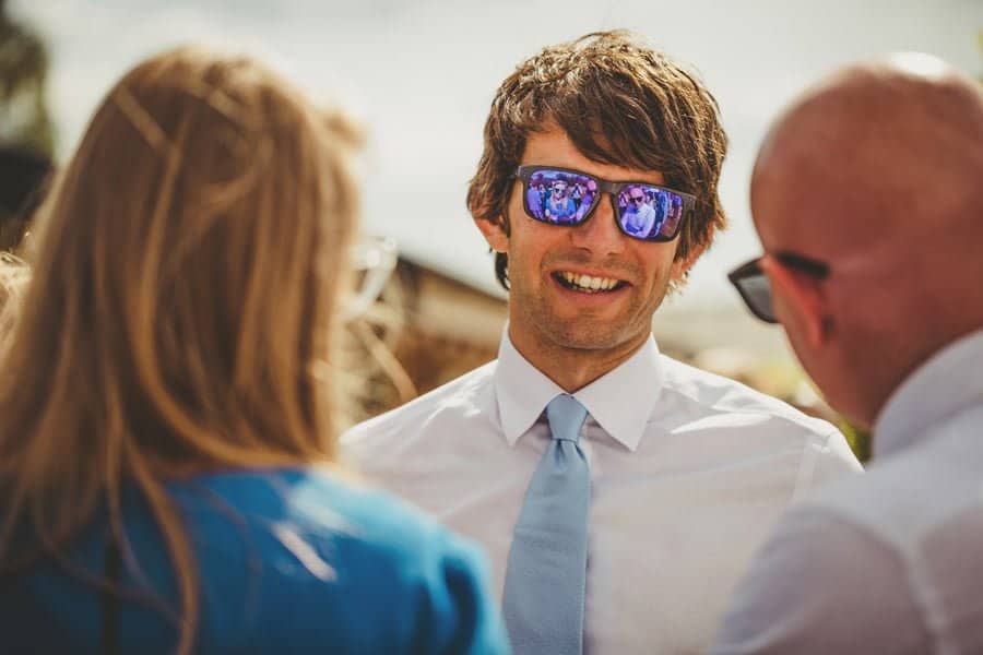 Wedding guests laugh and joke with each other