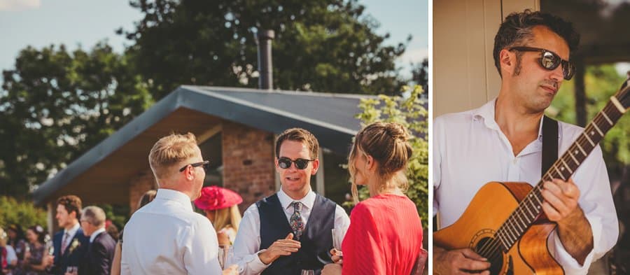 An usher talks to friends and a member of the wedding band plays a guitar