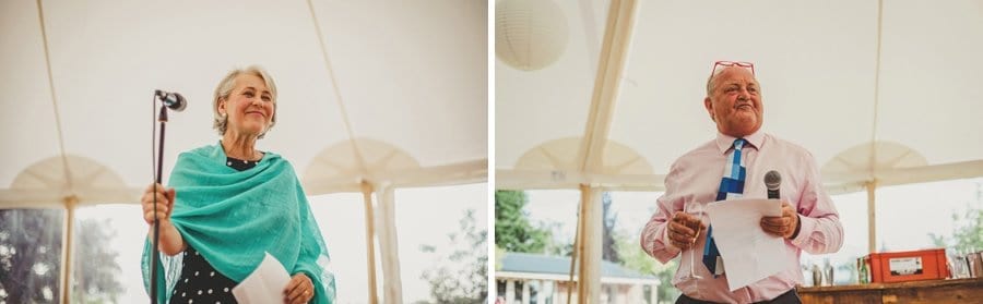 The brides mother and father stand up and deliver their speech to the wedding party