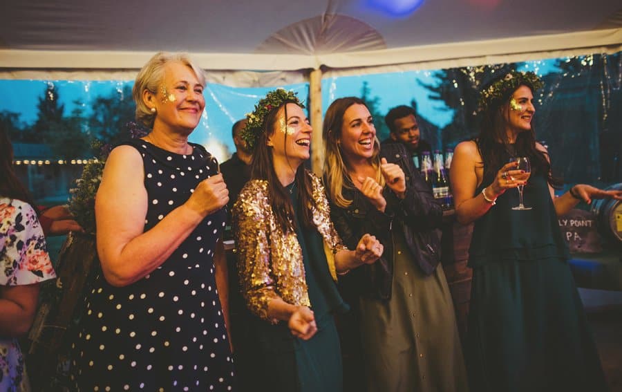 The brides mother and bridesmaids dance as they watch the bride and grooms first dance