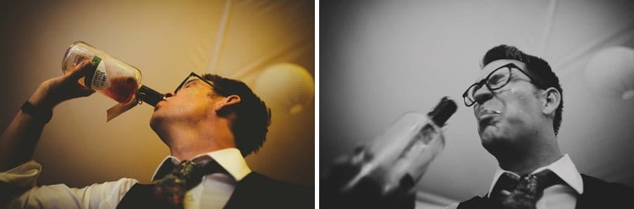 A wedding guest drinks whisky from a bottle in the marquee
