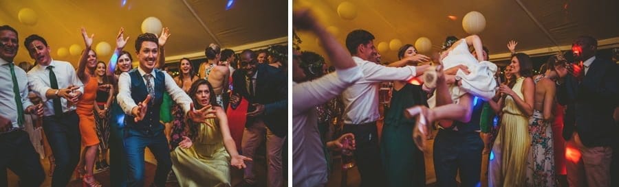 The groom holds his hands out and catches the bride as she runs into him