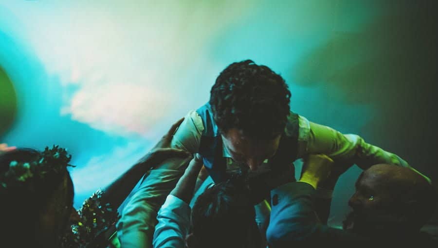 The ushers raise the groom into the air