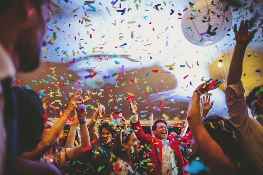 Confetti canons are fired into the air as wedding guests try and catch the confetti