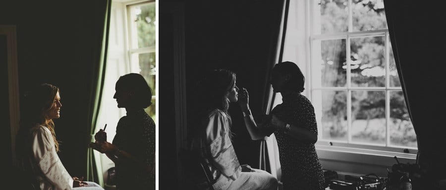 The bride shares a joke with the make up artist