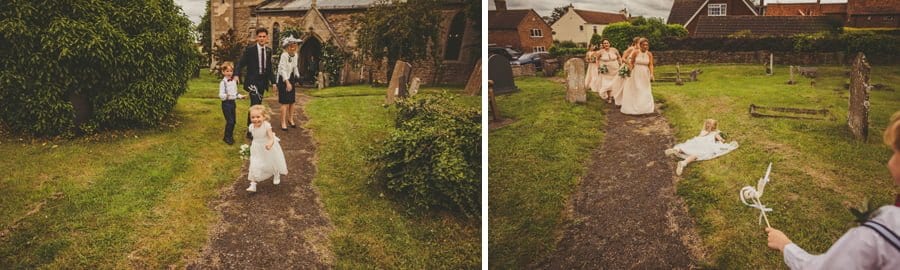 A flowergirl runs to her mother and trips on the grass outside the church