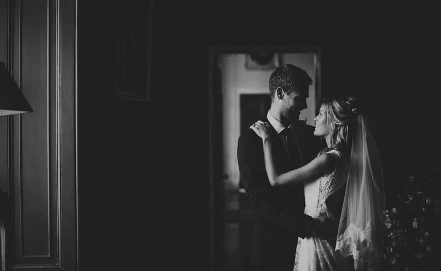 The bride and groom look at each other and pose for a photograph at Stubton Hall