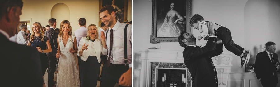 The bride and groom dance with friends and a man lifts his son up in the air