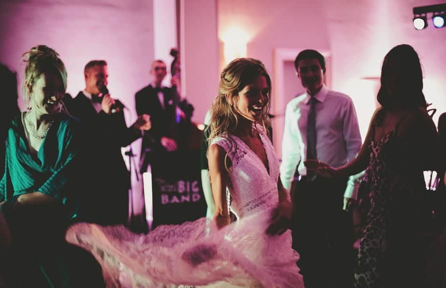 The bride dancing in front of her wedding guests