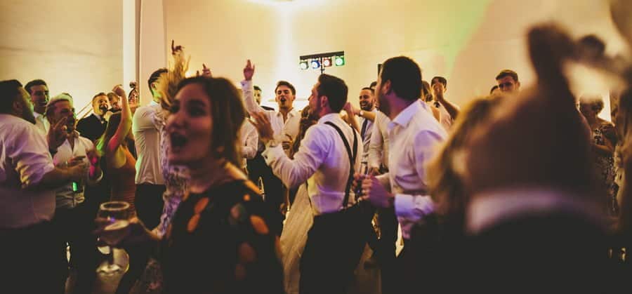 The best man and ushers form a circle in the middle of the dance floor