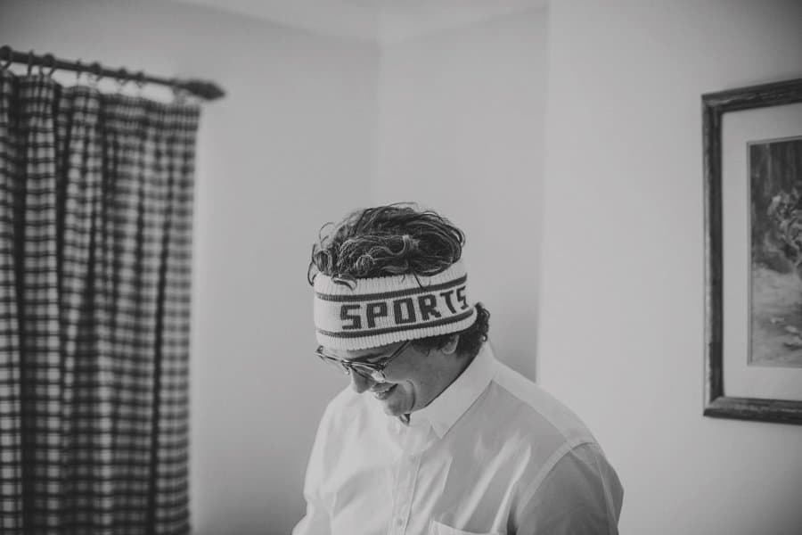 An usher smiles wearing a sports headband