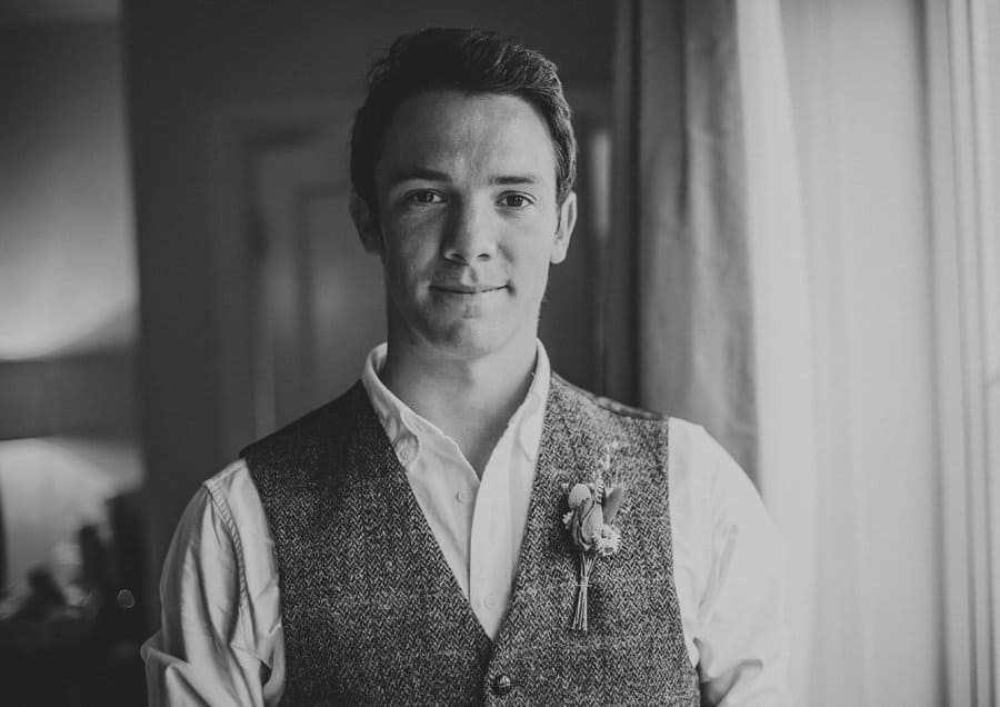 A portrait of one of the ushers stood next to a window