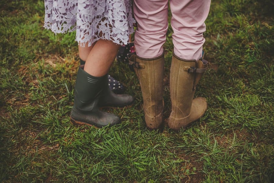 Wedding guests stood in the field with their wellington boots on