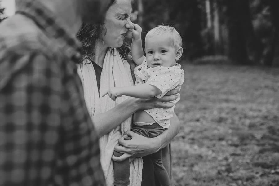 A little boy squeezes his mothers nose