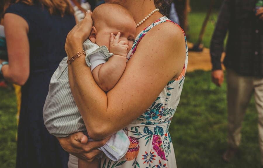 A mother holds her baby in her arms
