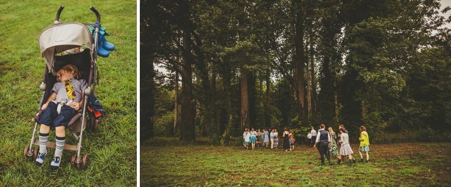Wedding guests walking into the woods where the wedding ceremony will be held