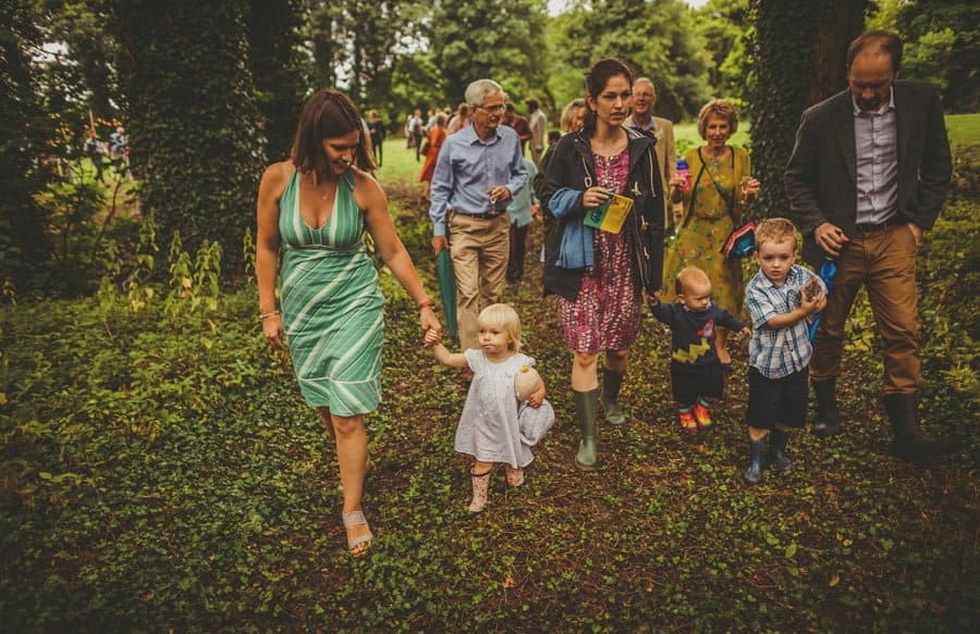 Wedding guests walk into the woods
