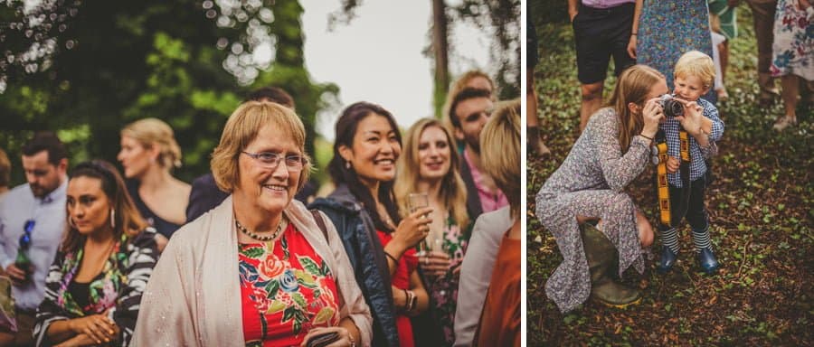 A wedding guest smiles as the groom arrives in the woods for the ceremony