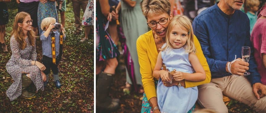 A little boy holds up his mothers SLR manual film camera