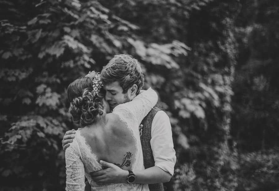 The groom holds the bride and cries