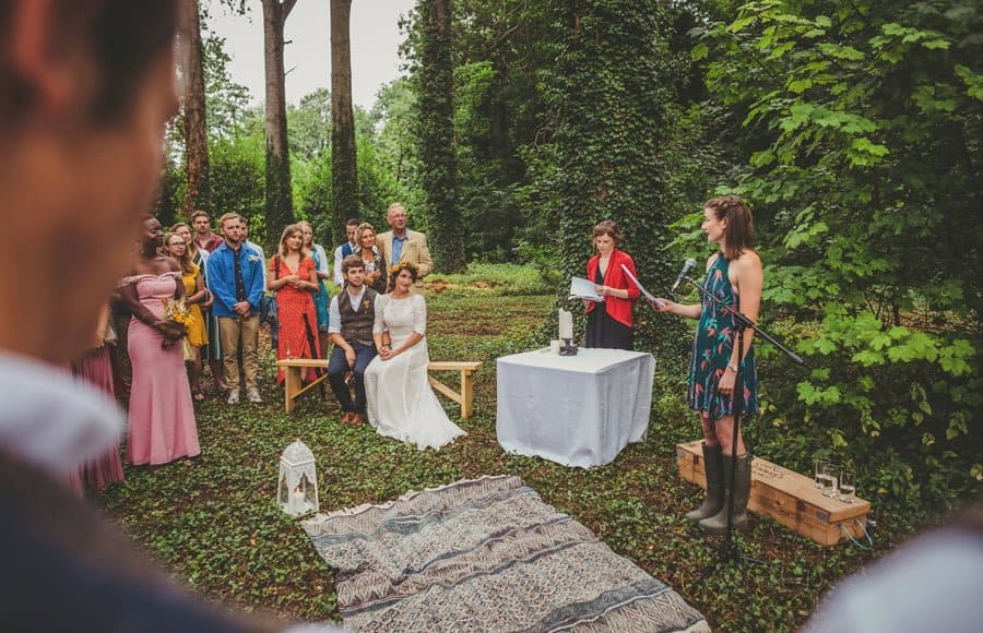 A wedding guest reads a poem to the bride and groom