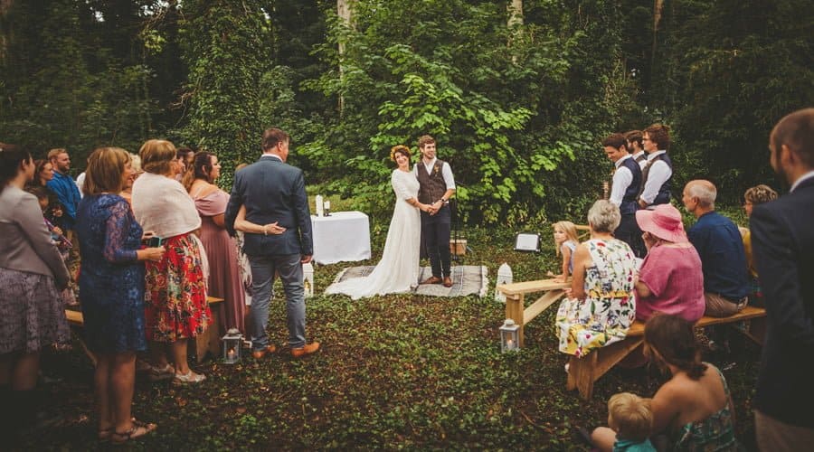 The bride and groom are congratulated by the wedding guests