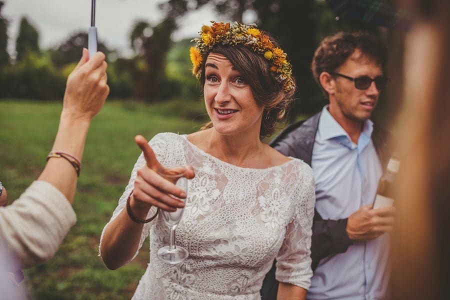 The bride points to a wedding guest