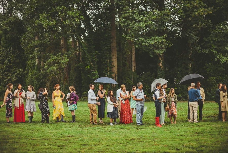 Wedding guests watch the running games on the school field