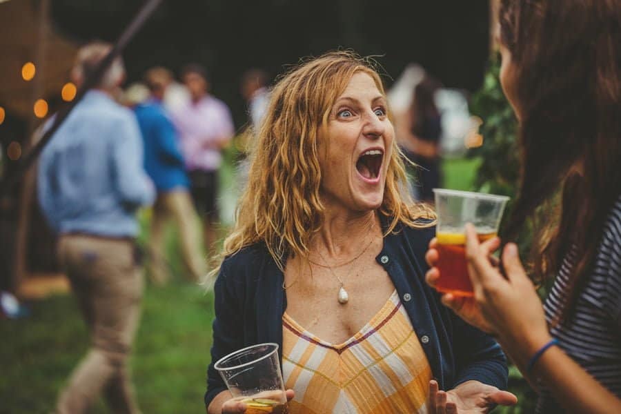 A lady laughs with her friend