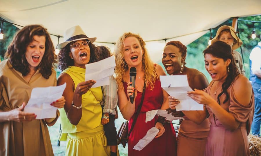 Wedding guests sing a song for the bride and groom