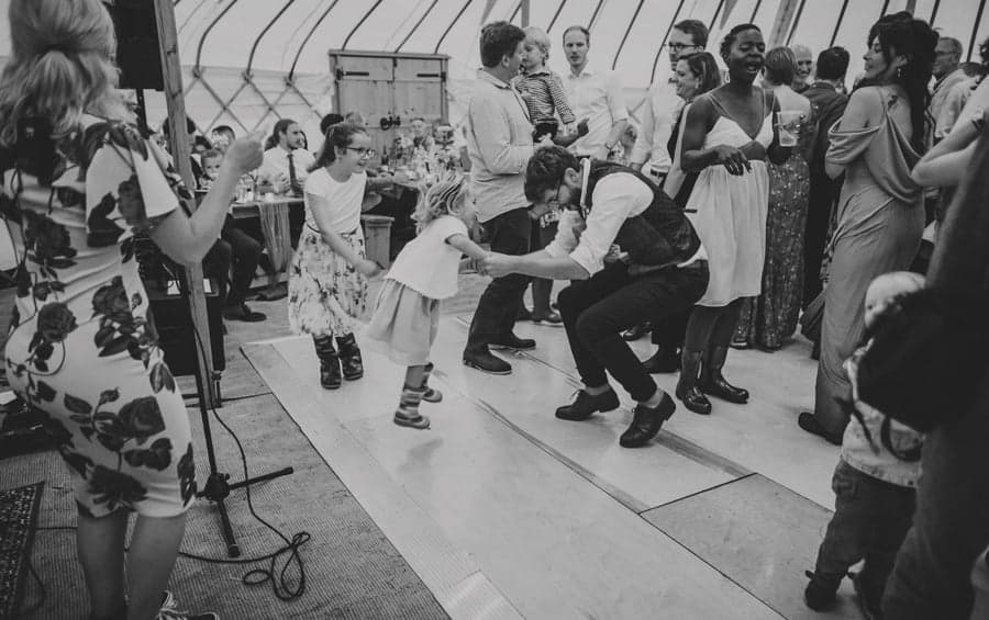 The groom dances with his niece on the dance floor