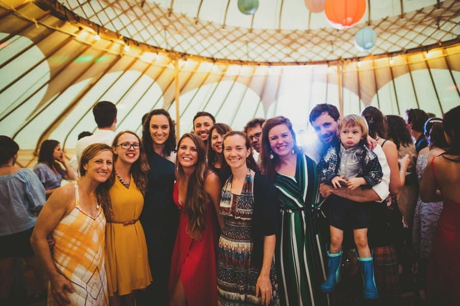 Wedding guests pose for a photograph inside the yurt