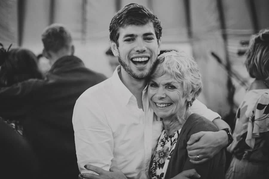 The groom and his mother pose for a photograph on the dance floor