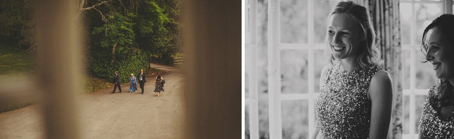 Wedding guests arrive at Barley Wood house as the bridesmaids look from one of the rooms