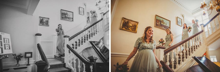 The bridesmaids walking down the main staircase at Barley Wood house